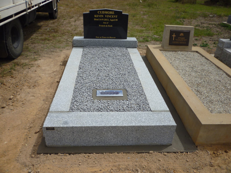Harcourt grey granite sawn and rustic monument with Adelaide black headstone and grey chip top.
